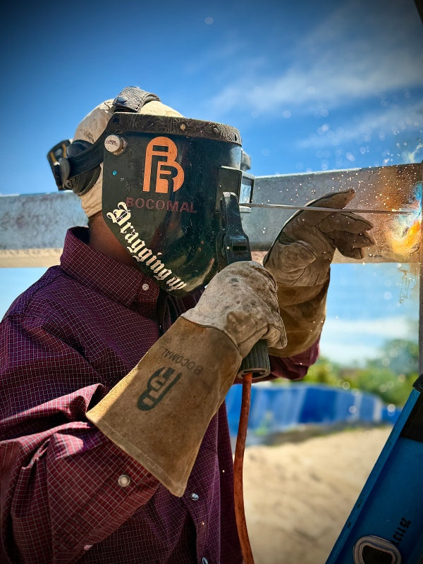Worker wearing FR gear using power tool