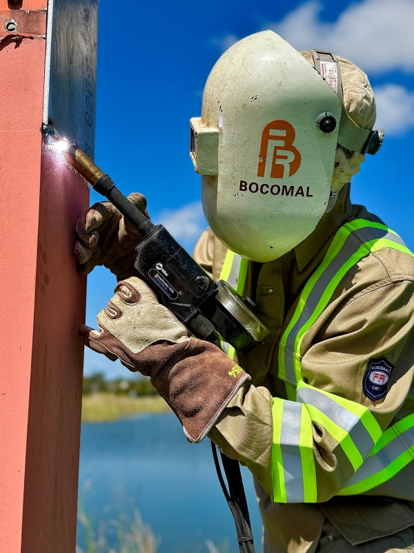 Welder in hi-vis FR clothing at work