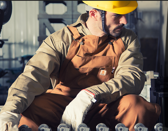 Welder in FR workwear wearing hard hat