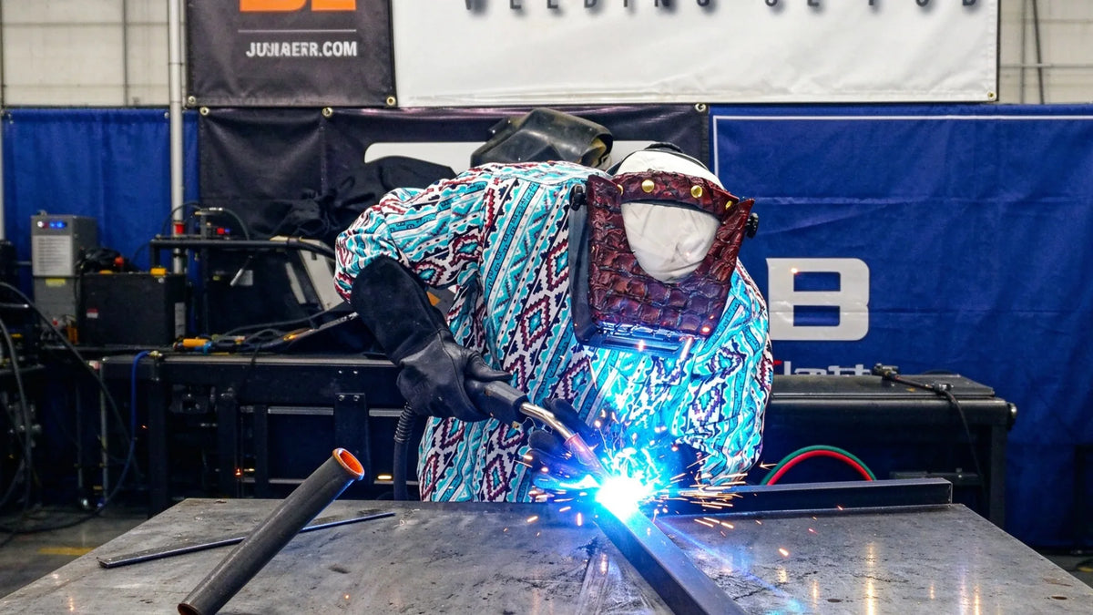 Welder in patterned arc-rated shirt at work