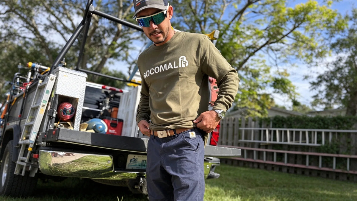 Electrical worker in FR clothing by service truck