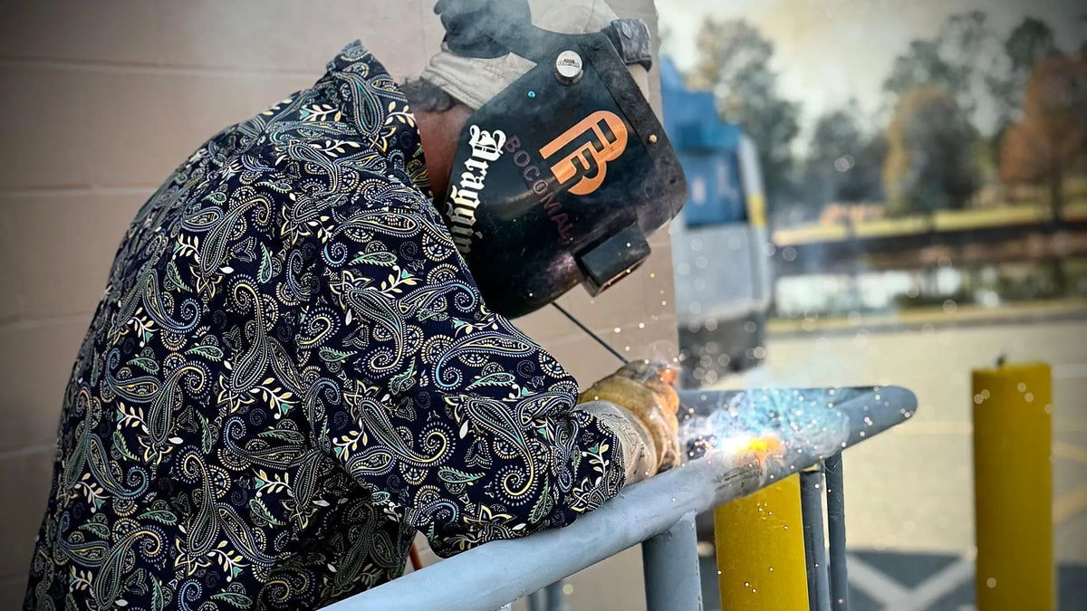 Welder wearing patterned FR workwear outdoors